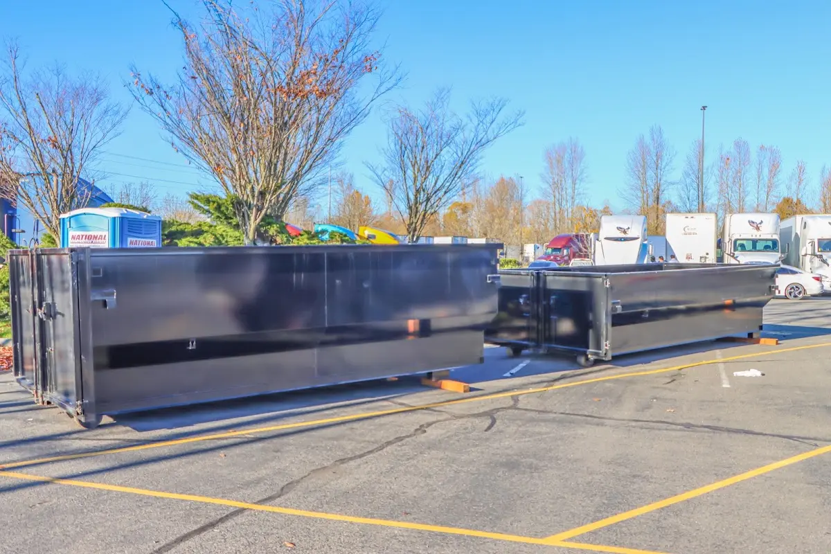 Professional dumpster rental service with roll-off container on residential driveway in Scott